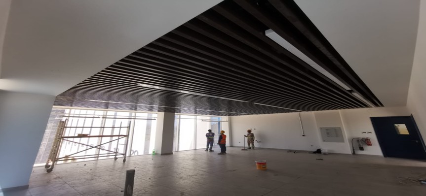 Modern commercial false ceiling with linear ceiling panels